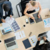 Overhead view of employees sitting around a conference table