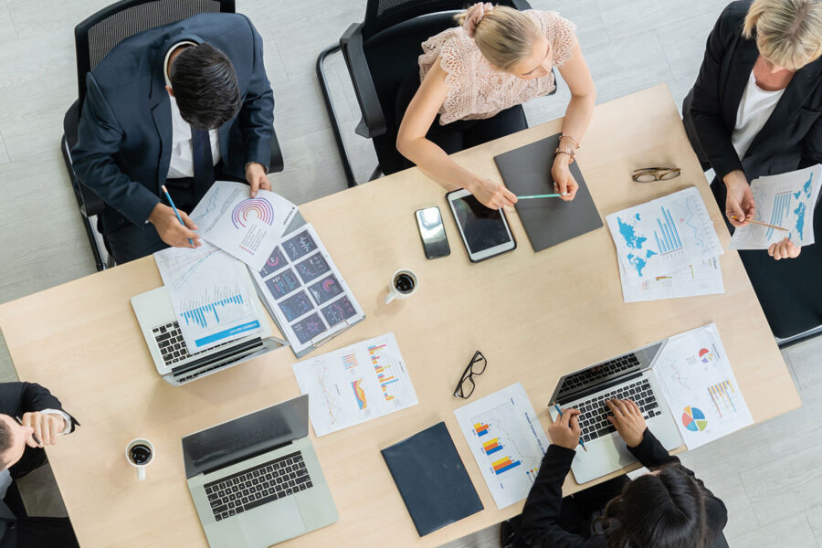 Overhead view of employees sitting around a conference table